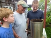 Jonah and Ezra helping Grandpa Bob roast